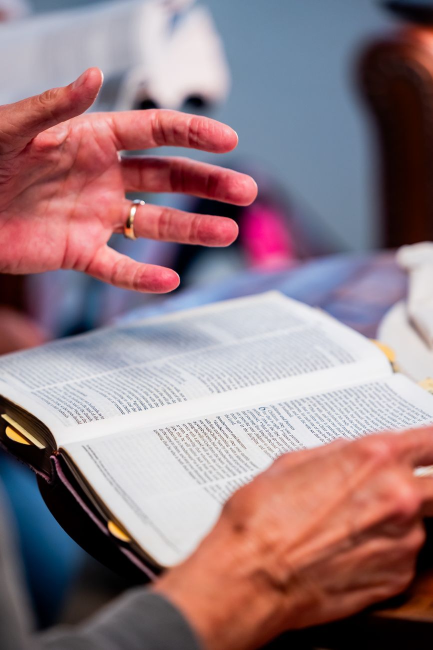 hands reading a bible at a study group